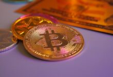 Golden bitcoin coin with other coins and card.