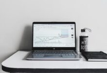 a laptop computer sitting on top of a white desk