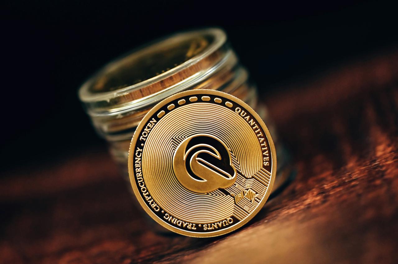 a stack of coins sitting on top of a wooden table