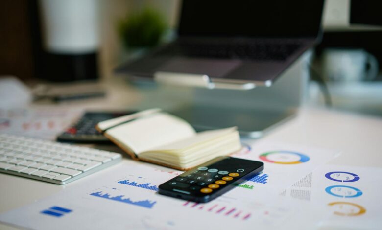 a remote control sitting on top of a table next to a book