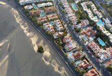 an aerial view of a city with sand dunes