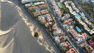 an aerial view of a city with sand dunes