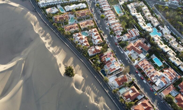 an aerial view of a city with sand dunes